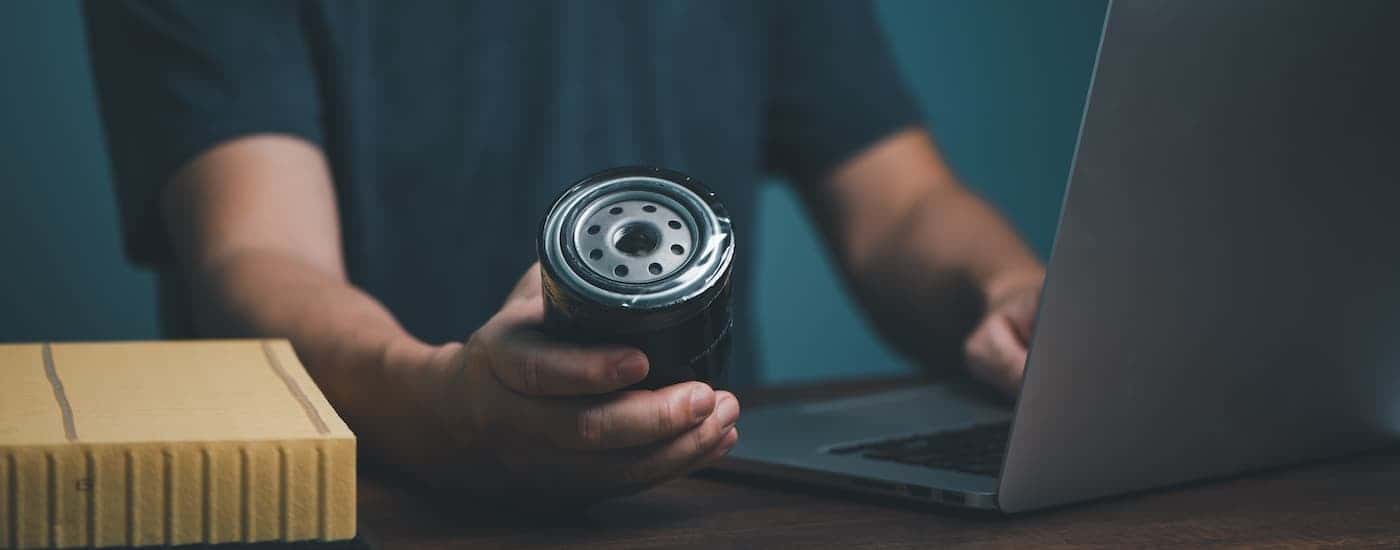 Technician holding an oil filter