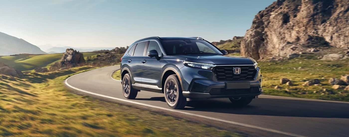 Black 2026 Honda CR-V driving along a winding road