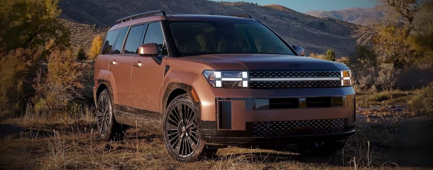 Brown 2026 Hyundai Santa Fe Hybrid parked off-road