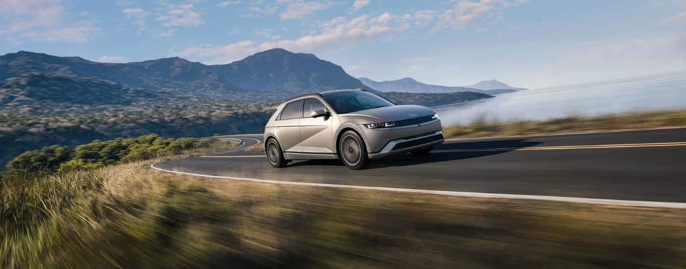 Grey 2026 Hyundai IONIQ 5 driving on a winding road