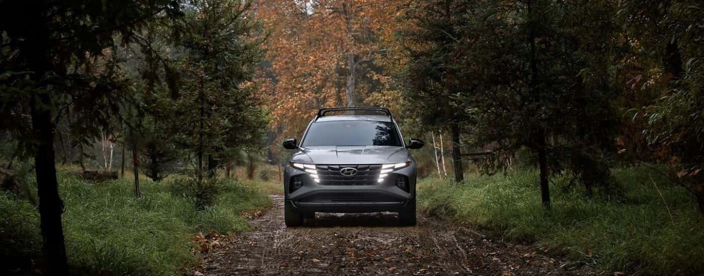 Silver 2023 Hyundai Tucson XRT driving down a trail