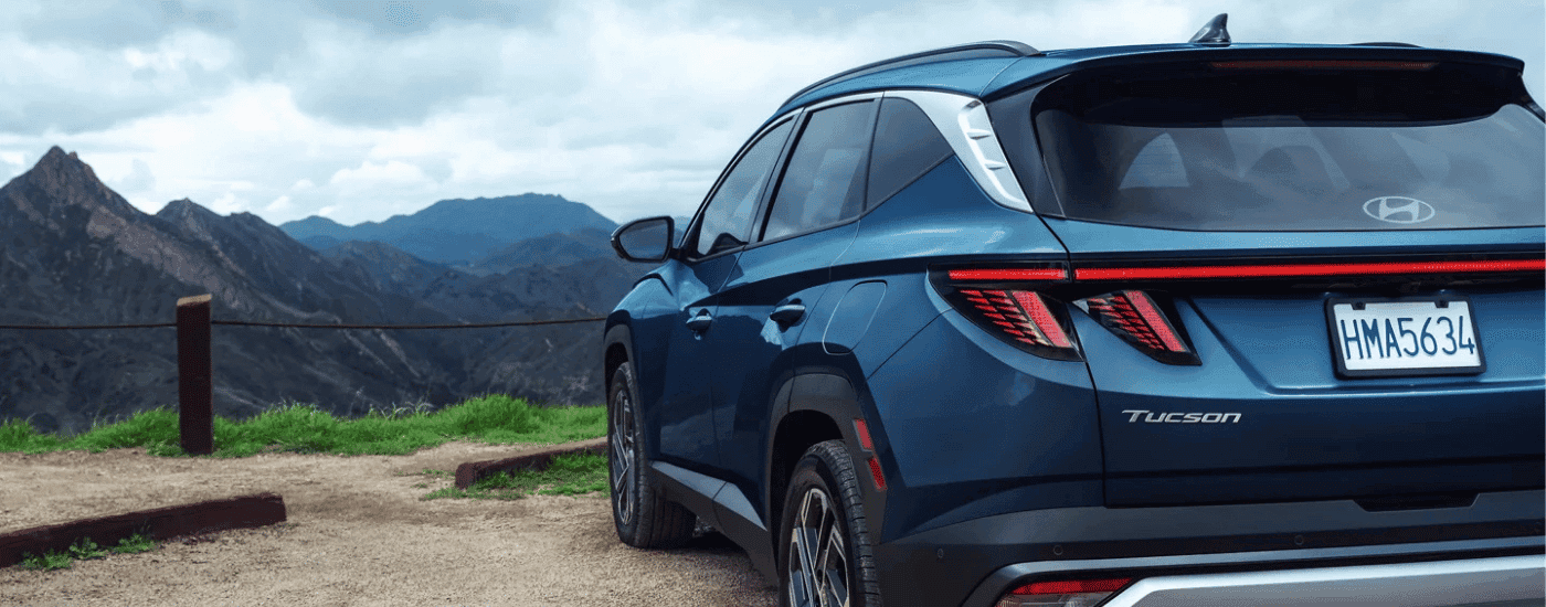 Blue 2026 Hyundai Tucson parked on the edge of a mountain