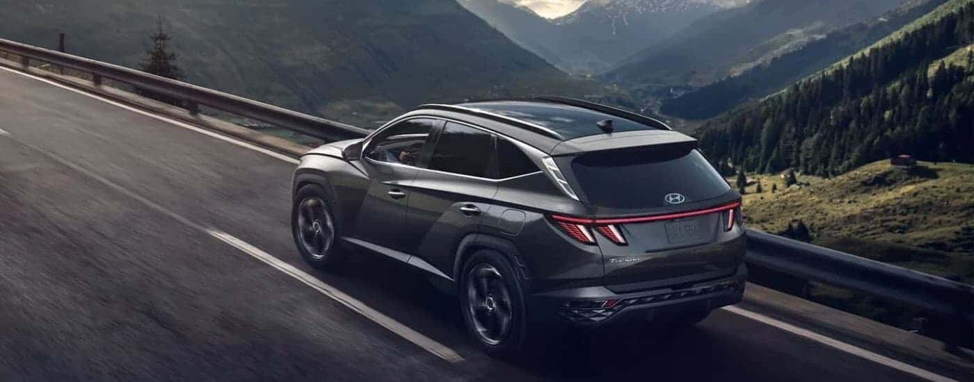 A gray 2026 Hyundai Tucson driving on a highway.