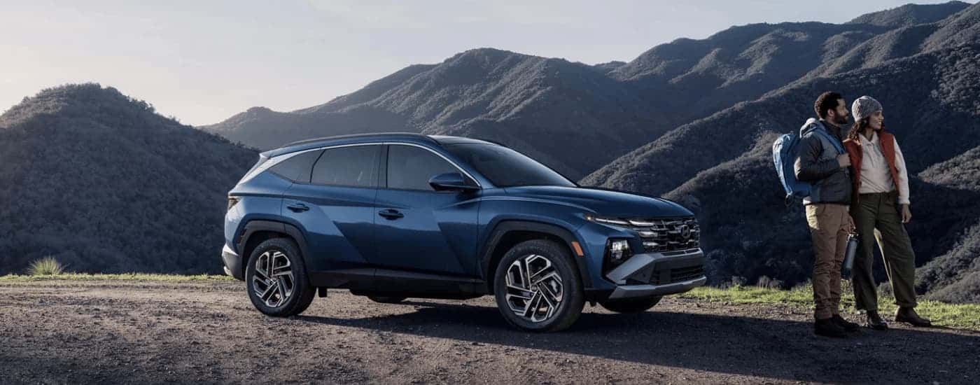 A blue 2026 Hyundai Tucson parked near mountains.