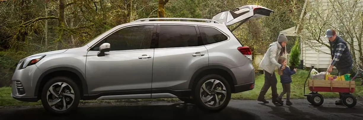 Family loading the trunk of a Subaru SUV