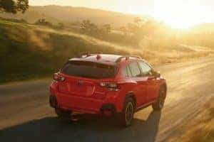 2022 Subaru Crosstrek driving on a country road into the sunset_mobile