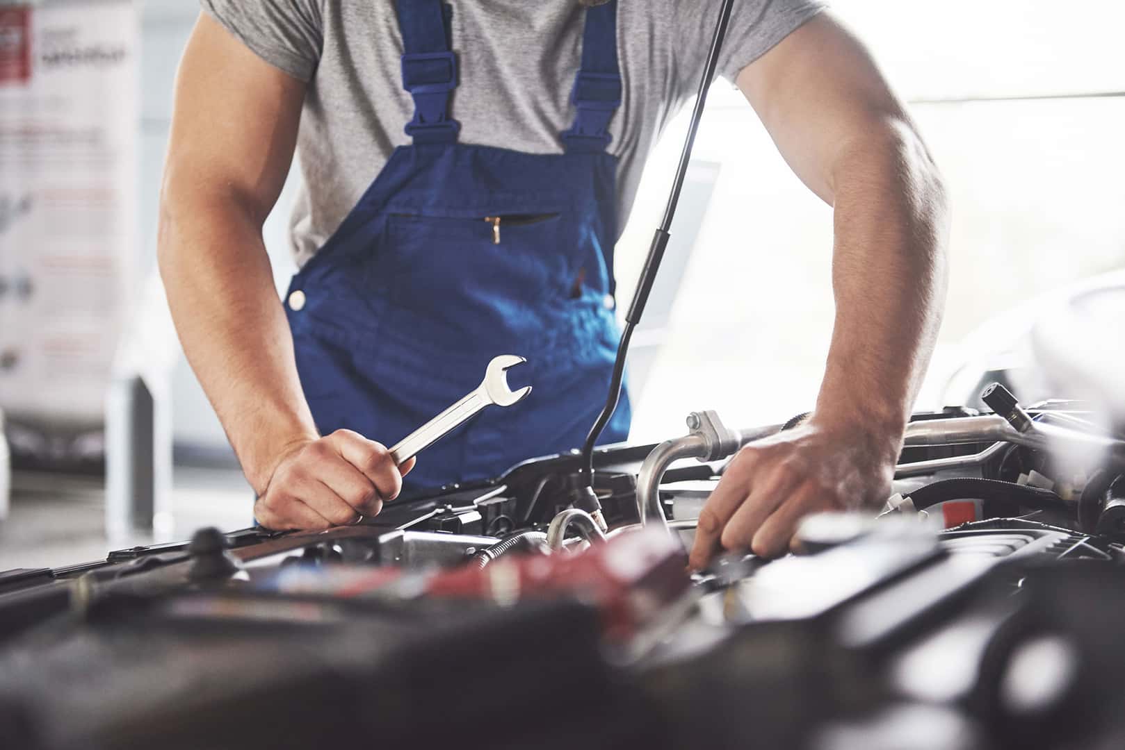 GMC service technician repairing a vehicle