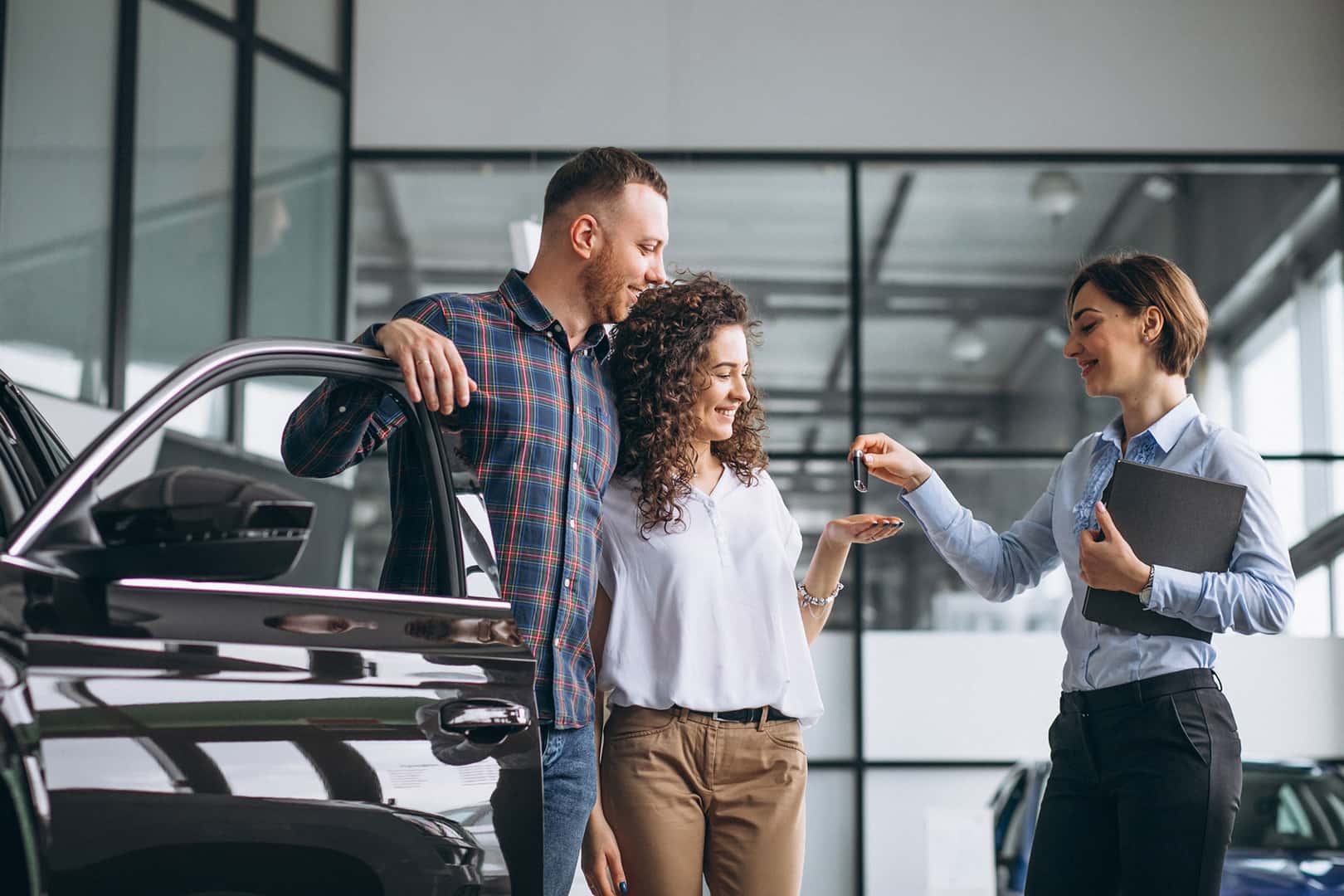 Young couple choosing a car in a GMC showroom