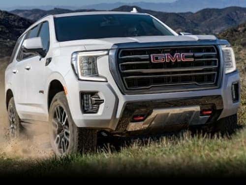 2024 GMC Yukon offroading up a hill