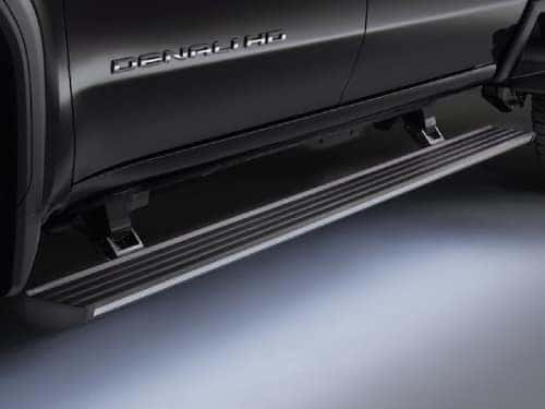 2024 GMC Sierra HD Denali close up view of retractable steps and LED lighting