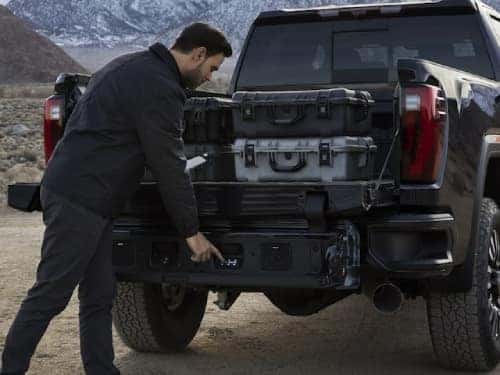 2024 GMC Sierra HD Denali view of man using multipro tailgate