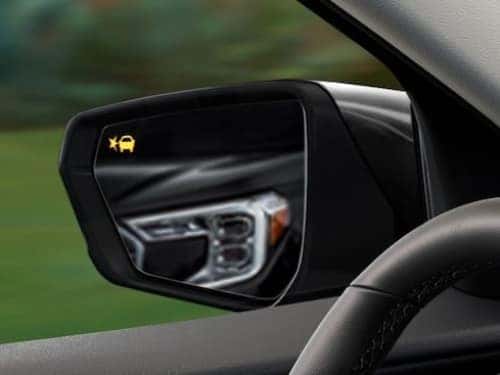 2024 GMC Terrain AT4 view of side mirror with blind spot alert lit up