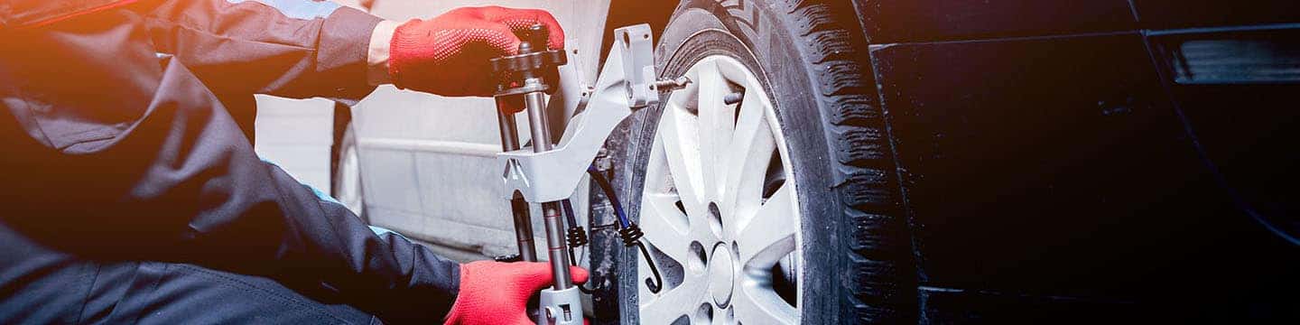 Close up view of a service tech doing an alignment service
