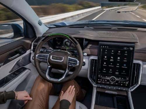 2024 GMC Acadia overhead view of woman in driver seat with hands in lap while vehicle is in super cruise mode