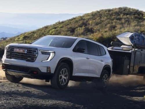 2024 GMC Acadia Denali towing a small enclosed trailer