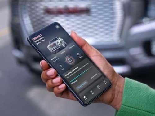 2024 GMC Savana Cargo Van view of myGMC Mobile App on phone