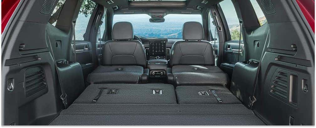 Interior cargo space of a 2026 GMC Acadia with second and third-row seats folded flat.