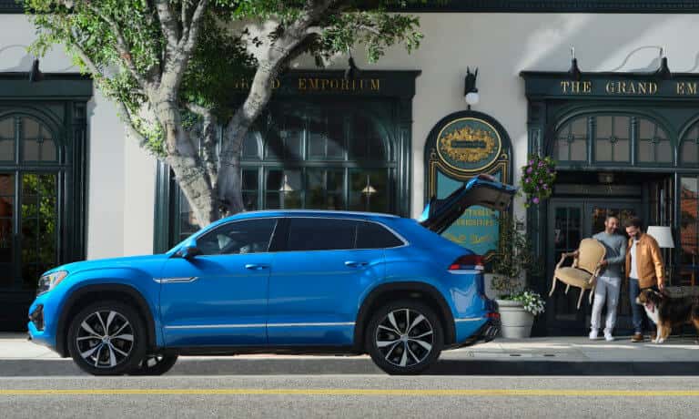 2026 Volkswagen Atlas Cross Sport in front of shop with trunk open